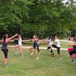 female student leading students in exercise