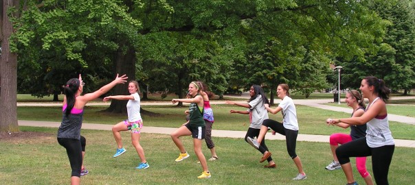 female student leading students in exercise