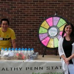 students posing at the prize wheel