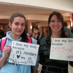 two females holding a sign